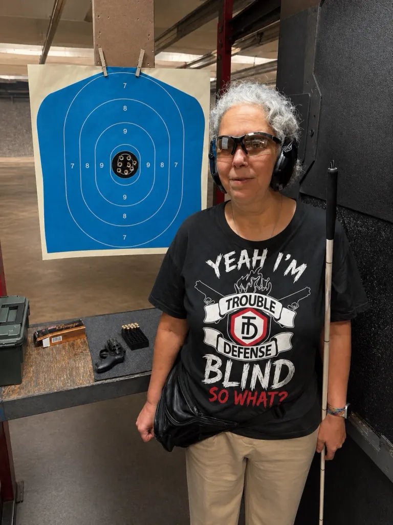 A Trouble Defense adaptive training participant standing beside a target at an indoor range